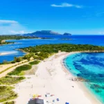 Aerial view of Bados, nice sandy beach with the mountains and the islands in background, North Sardinia,Olbia