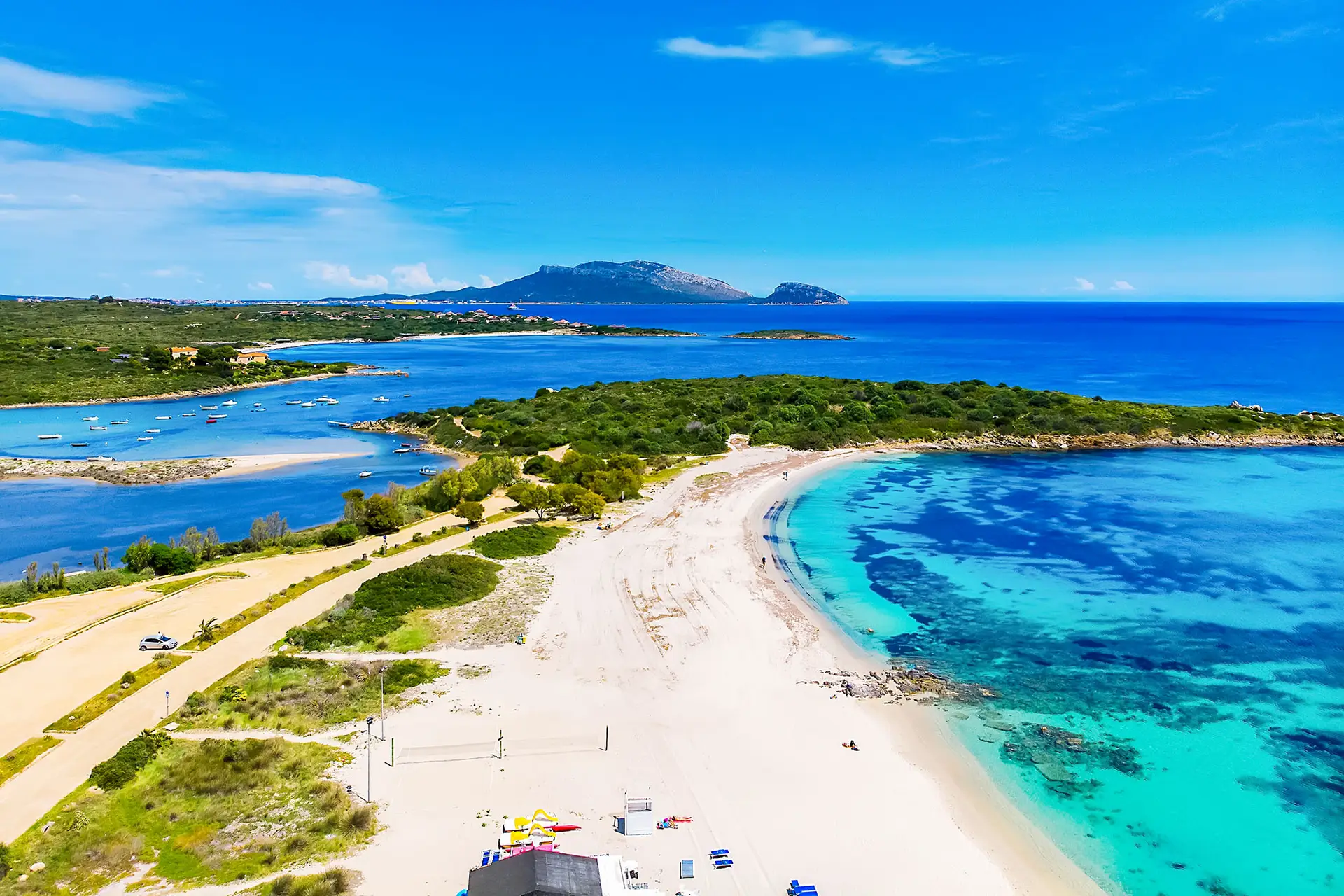 Aerial view of Bados, nice sandy beach with the mountains and the islands in background, North Sardinia,Olbia